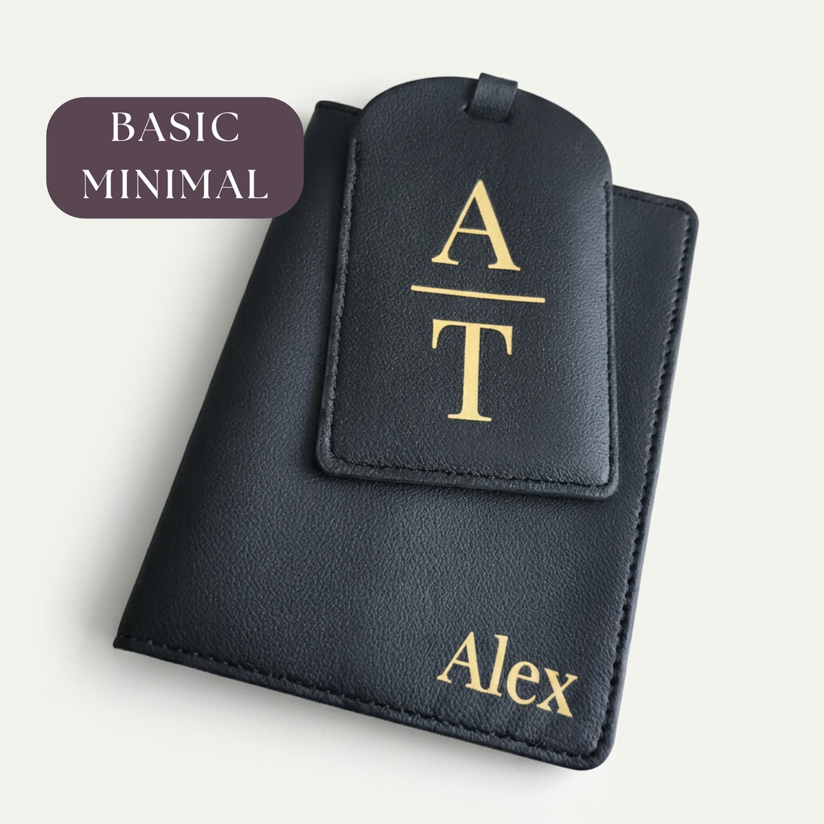 Black passport organiser with gold name Alex and matching luggage tag with stacked initials A and T